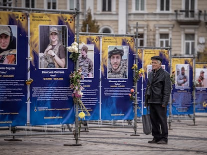 KYIV, UKRAINE - OCTOBER 19: People walk past and look at an exhibition in Sophia Square of photographs of Azov battalion soldiers killed at the siege of Mariupol on October 19, 2022 in Kyiv, Ukraine. Recent Russian attacks around Kyiv and across Ukraine have targeted power plants, killing civilians and employees of key infrastructure. (Photo by Ed Ram/Getty Images)