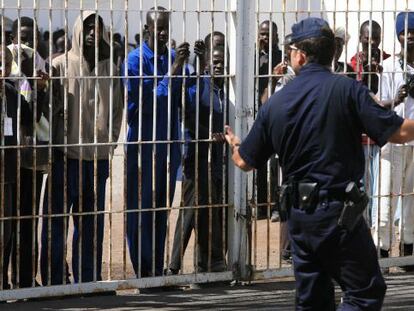 A policeman with immigrants in an internment center in the Canary Islands.