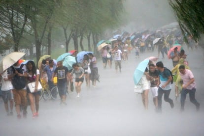 Habitantes de Hangzhou caminan bajo las fuertes lluvias que preceden al tifón Soudelor, en Taiwán.