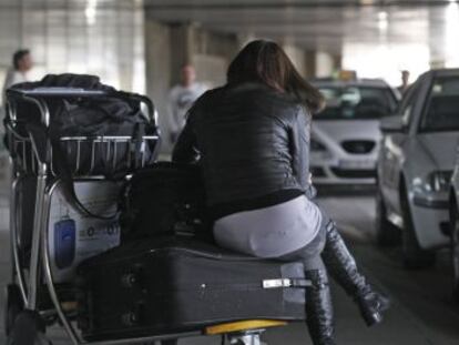 Una mujer aguarda su turno para coger un taxi en la terminal 4 de Barajas.