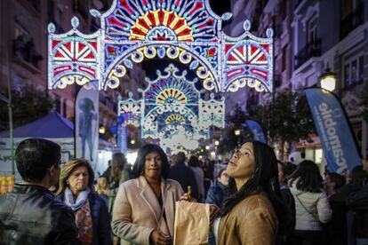 Unas turistas observan las luces ornamentales que estos díass decoran las calles de Valencia.