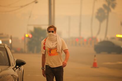 A person protecting himself from the smoke in Los Angeles on Tuesday.