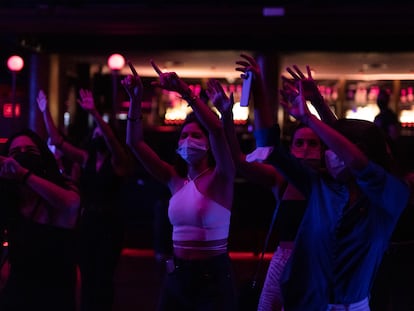 Patrons wearing masks dance in Barcelona's Sala Apolo in a file photo from October.