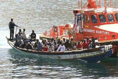 Una gran piragua con 56 inmigrantes a bordo, conducida al puerto de Los Cristianos, al sur de Tenerife.