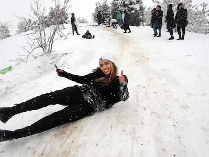 Una mujer iraní se desliza en la nieve en un parque de Teherán, el 12 de febrero de 2023.