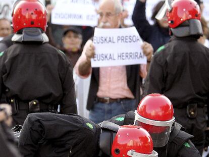 Dos<i> ertzainas</i> reducen a un manifestante.