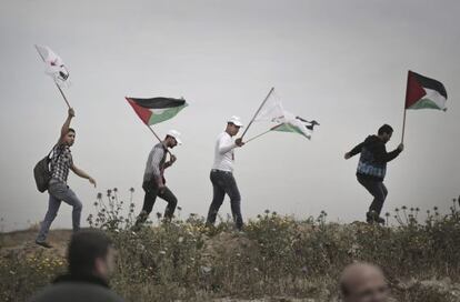 Manifestantes palestinos ondean banderas durante la celebraci&oacute;n del &quot;d&iacute;a de la tierra&quot;, el domingo.