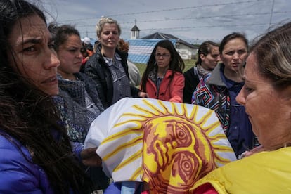 Un grupo de mujeres sostiene una bandera Argentina tras rezar frente a la Base Naval de Mar de Plata, el 20 de noviembre de 2017.