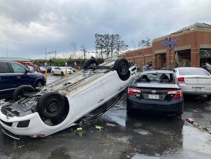 A car is upturned in a Kroger parking lot after severe storm swept through Little Rock, Ark., Friday, March 31, 2023