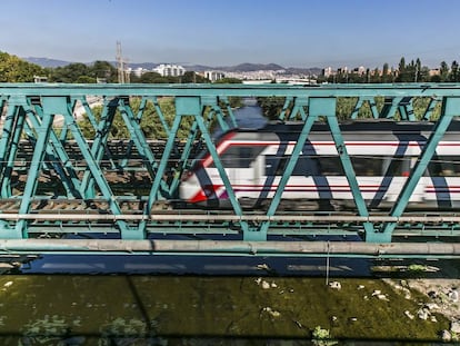 Un tren pasa por el puente que cruza el Besós.