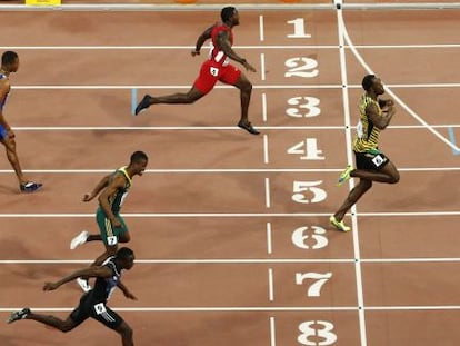 Usain Bolt cruza la línea de meta seguido de Gatlin