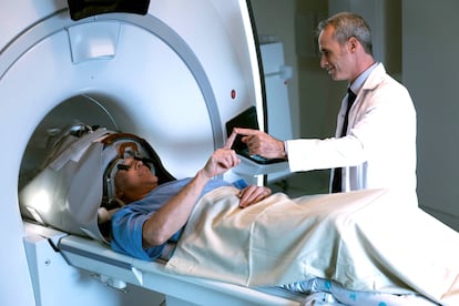 A patient and his physician during a treatment for neurological tremors in a high-frequency ultrasound machine.