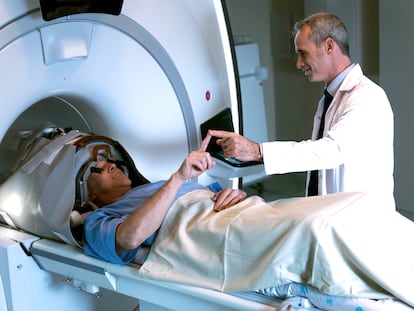 A patient and his physician during a treatment for neurological tremors in a high-frequency ultrasound machine.