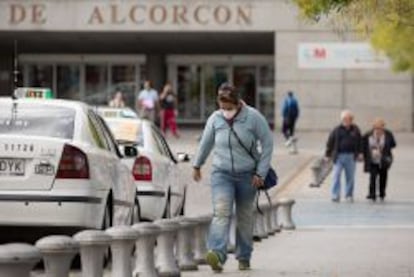 Una ciudadana camina con mascarilla en las proximidades del hospital de Alcorc&oacute;n.