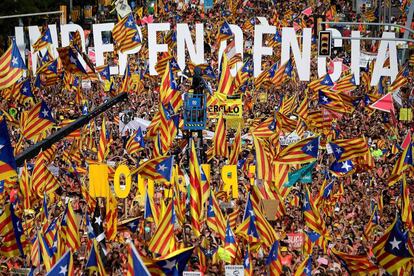 People wave pro-independence flags at the Diada march.