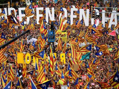 People wave pro-independence flags at the Diada march.