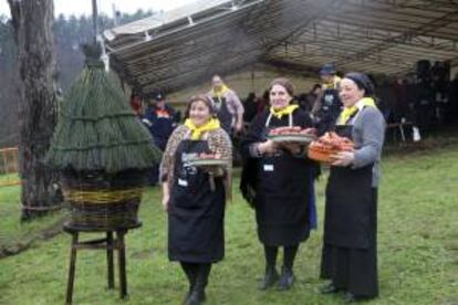Fotografía facilitada por el Ayuntamiento de Lalín (Pontevdra) de varias mujeres mostraon los chorizos elaborados durante la recreación de la matanza tradicional del cerdo, hoy en la localidad pontevedresa.