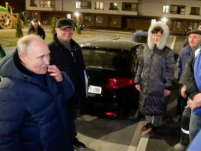In this photo taken from video released by Russian TV Pool on Sunday, March 19, 2023, Russian President Vladimir Putin talks with local residents during his visit to Mariupol in Russian-controlled Donetsk region, Ukraine.