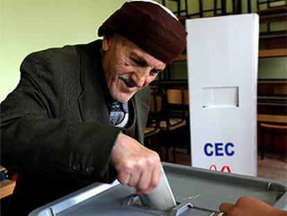 Un anciano deposita su voto en un colegio electoral de Pristina, la capital kosovar.