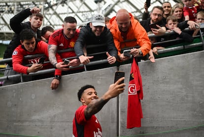 Jadon Sancho se hace una fotografía con aficionados del Manchester United.