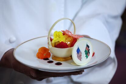 Dessert: white chocolate basket with banana ganache, raspberries, peaches and candied lime zest.