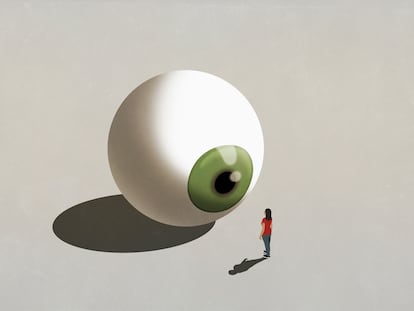 Woman standing at large green eyeball