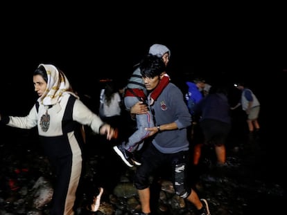 Migrantes afganos desembarcan de un bote en una orilla cerca de la aldea de Skala Sikamias, el pasado enero en la isla de Lesbos (Grecia).