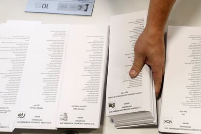 Papeletas de las candidaturas durante los preparativos para la jornada de votación en el colegio electoral instalado en el CEIP Pi i Margall de Madrid.
