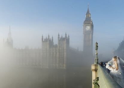 La niebla envuelve Londres mientras una novia posa para una fotografía en el puente de Westminster.