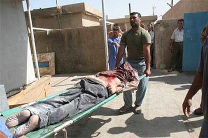 El cadáver de uno de los empleados del aeropuerto de Bagdad es trasladado a un hospital de la capital iraquí.