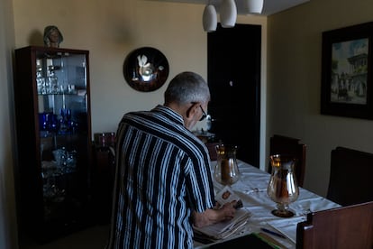 Mestre with photographs of his daughter Nancy Mariana. 