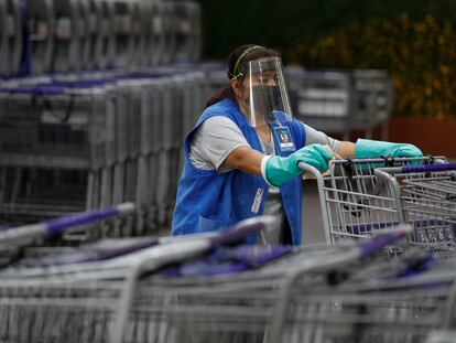 Una mujer desinfecta los carritos del supermercado en Ciudad de México, el 15 de junio.