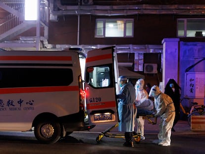 In Beijing, medical personnel put a patient inside an ambulance, on Friday, November 9, 2022.