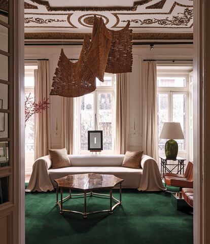 Salón de la casa de Mafalda Muñoz y Gonzalo Machado en Madrid, con una escultura textil de Aurelia Muñoz suspendida del techo