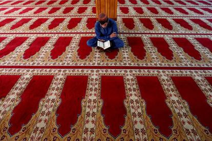 Un joven lee el Corán en una mezquita de Kabul (Afganistán), el primer día del Ramadán.