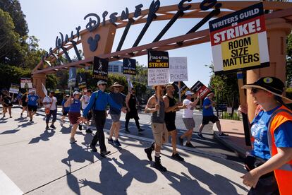 SAG-AFTRA actors and Writers Guild of America (WGA) writers walk the picket line outside Disney Studios in Burbank, California, on July 25, 2023.