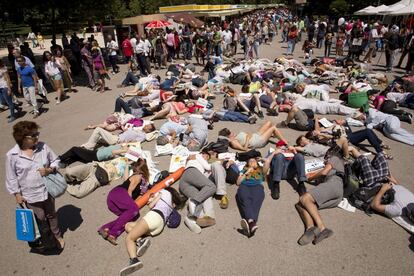 Unas personas se tumban en el suelo durante una protesta a favor de las energías renovables en la Feria del Libro, el 30 de mayo de 2015.