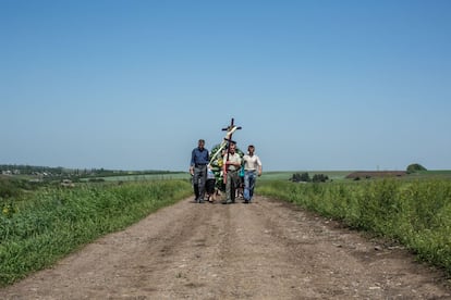 Los dolientes tranportan el ataúd de Elena Ott, de 42 años, de la casa de su familia a un cementerio de Starovarvarovka, Ucrania. Ott fue asesinada dos días antes cuando el coche en el que viajaba fue tiroteado por el ejército ucraniano, según cree su familia.