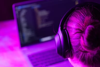 Una mujer usando auriculares inalámbricos.