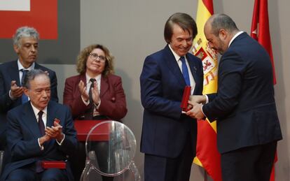 El presidente en funciones de la Comunidad de Madrid, Pedro Rollán (a la derecha), hace entrega al cantante Raphael de la Medalla de Oro.