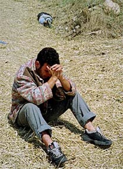 Un albanés, junto al cadáver de un vecino después de identificarle.