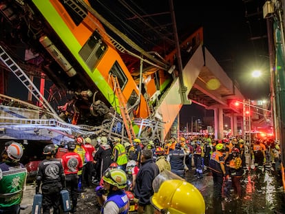 Trabajadores humanitarios y rescatistas frente a los escombros después de que una sección de un puente en la línea 12 del metro de Ciudad de México colapsara, el 3 de mayo de 2021.