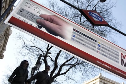 One of the ads for Madrid Metro over a subway entrance.