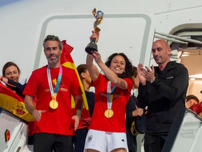 Ivana Andrés, entre Jorge Vilda y Luis Rubiales, enseña la Copa del Mundo tras aterrizar en Madrid el pasado día 21 de agosto.