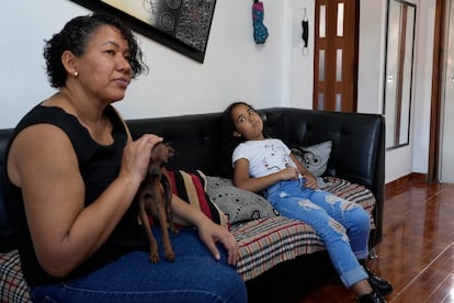 Valerie Torres listens as her mother Francys Brito speaks during an interview in their home in Caracas, Venezuela, on Sunday, February 26, 2023.