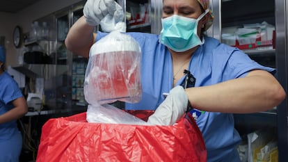 Melissa Mattola-Kiatos, RN, Nursing Practice Specialist, removes the pig kidney from its box to prepare for transplantation at Massachusetts General Hospital, Saturday, March 16, 2024, in Boston, Mass.