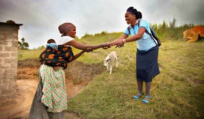 Una trabajadora sanitaria rural saluda a una campesina en la región de El Cabo, en Sudáfrica
