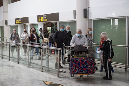 Tourists leave the arrivals zone at Lanzarote airport on October 24. 