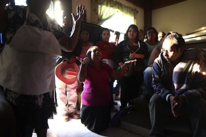 Edgar Tamayo's family prays in Miacatlán, Morelos state, Mexico.