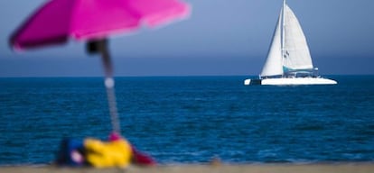 Un catamar&aacute;n navega pr&oacute;ximo a la playa de la Malagueta, en M&aacute;laga.